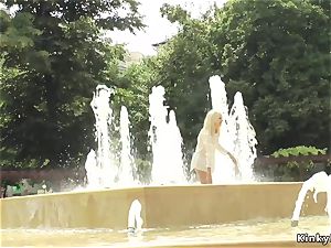 light-haired made to bathtub in public fountain