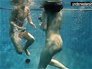 two handsome amateurs demonstrating their figures off under water
