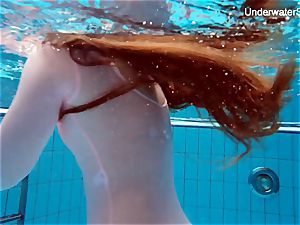 red-haired Simonna flashing her figure underwater